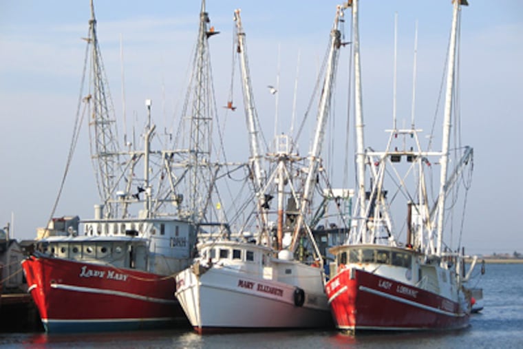 The Lady Mary (left), a 71-foot scallop boat seen here moored in Cape May Harbor, sank at about 5 a.m. on Tuesday march 24, 2009 with seven people aboard about 75 miles off the coast. Only one crew member was conscious and alert when he was plucked with two others from the water by a helicopter. (AP Photo/U.S. Coast Guard, Seaman Daniel Kehlenbach)