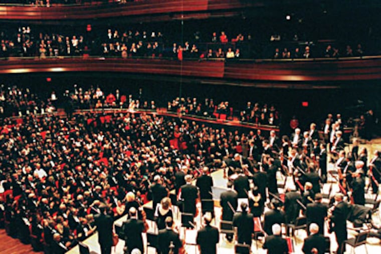 Members of the Philadelphia Orchestra stand at the Kimmel Center's Verizon Hall during a performance in 2001, the year the center opened. (Jennifer Midberry / Staff Photographer)