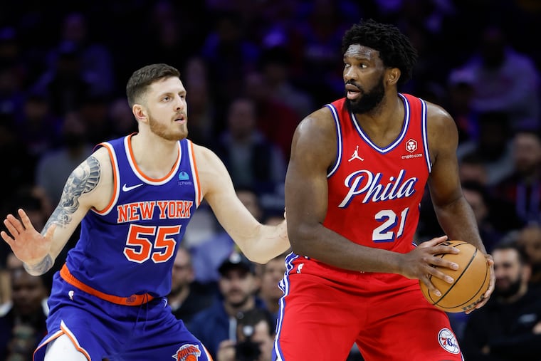 Sixers center Joel Embiid holds the basketball against New York Knicks center Isaiah Hartenstein on Friday, January 5, 2024 in Philadelphia.