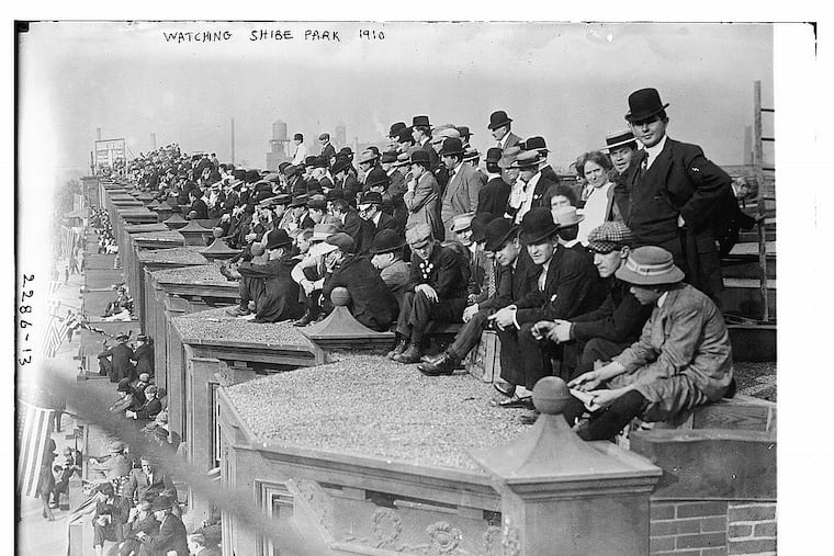 Fans take in a World Series game between the Philadelphia A's and the Chicago Cubs on the rooftops of rowhouses overlooking Shibe Park in October 1910.