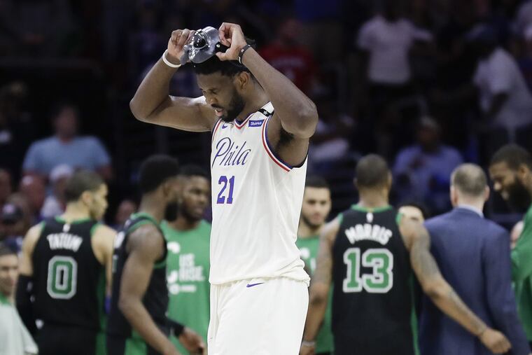 The Sixers’ Joel Embiid walks off the court after Boston’s Al Horford hit a late shot in overtime of Game 3 of the Eastern Conference semifinals on Saturday.