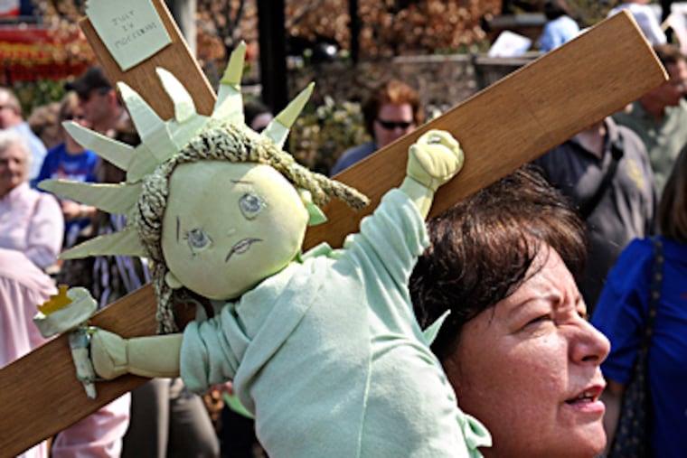 A Statue of Liberty on a crucifix, made by South Philadelphia resident Mary DeChristopher for the Independence Mall rally. TOM GRALISH / Staff Photographer