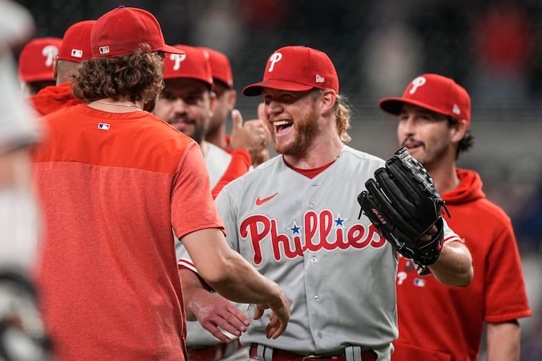 Phillies relief pitcher Craig Kimbrel (center) celebrates with teammates after closing out the 6-4 win. It was his 400th career save.