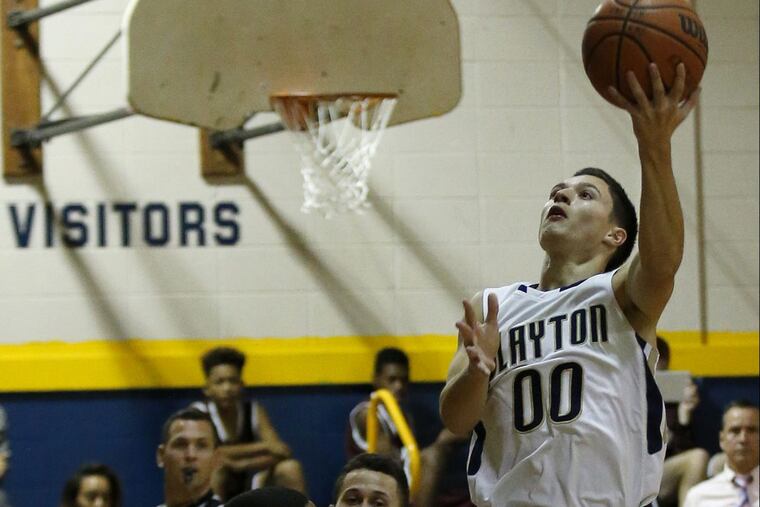 Clayton High’s Mahir Yilmaz (right) attempts to lay-up the basketball against Wildwood High’s Trayvon Young during the first-quarter of a game on Monday, Dec. 19, 2016. Clayton lost to Paulsboro, 81-63, on Monday.