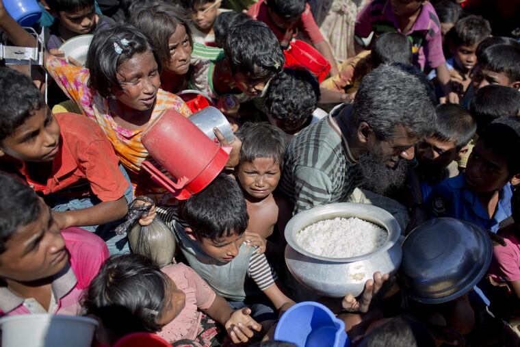 A Rohingya Muslim child cries as she and others wait to receive food distributed from a Turkish aid agency at the Thaingkhali refugee camp in Ukhiya, Bangladesh on Nov. 14.