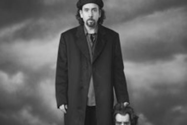 Director Tim Burton was photographed with the prop head of Jonathan Masbath, a character killed by the Headless Horseman in Burton's "Sleepy Hollow."