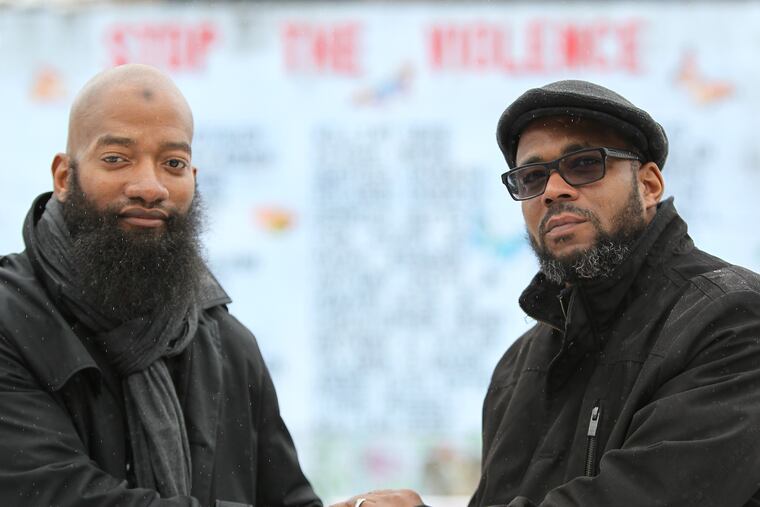 In this February 2014 file photo, William Little (left), who spent 10 years in prison for the 1989 murder of Terrence Brice, poses with the victim's brother Clarence Hatton. Hatton forgave Little and the two now work together to teach forgiveness and redemption through an organization they cofounded.