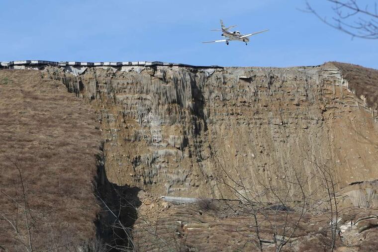 The crumbling end of Yeager Airport in Charleston, W. Va., where a landslide broke loose Thursday, taking out power lines, trees, a vacant home, and a church. More rain is forecast.