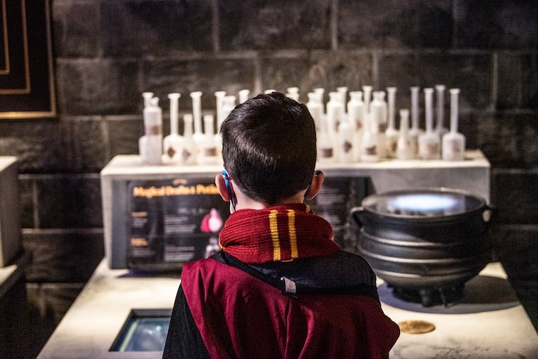 Kieran Goh, 8, creates an elixir in the Potions classroom at "Harry Potter: The Exhibition" at the Franklin Institute.