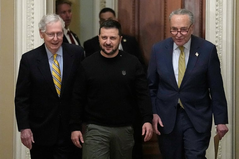 Ukrainian President Volodymyr Zelensky (center) walks with Senate Minority Leader Mitch McConnell (left) and Senate Majority Leader Chuck Schumer during Tuesday's visit to Capitol Hill.