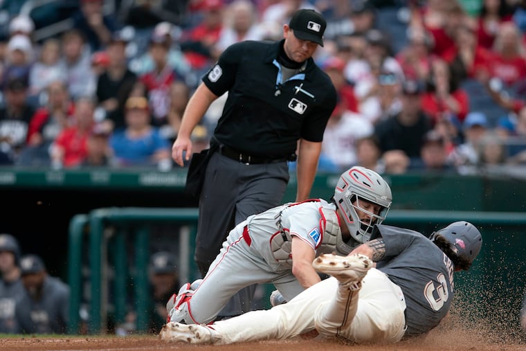 Phillies catcher Garrett Stubbs tags out the Nationals' Dylan Crews at the plate in the second inning.