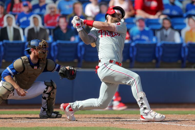 Philadelphia Phillies' Bryce Harper strikes in front of Toronto Blue Jays catcher Danny Jansen during the ninth inning of a baseball game Sunday, May 16, 2021, in Dunedin, Fla.