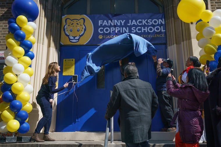 Principal Kelly Espinosa, left, along with others, reveals the new sign in honor of Fanny Jackson Coppin, the trailblazing educator, at the South Philadelphia school which used to be named for Andrew Jackson.