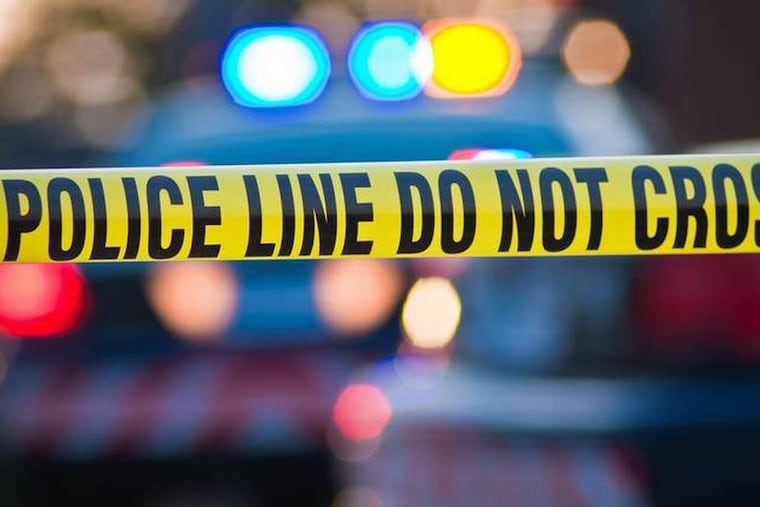 Police tape blocks a crime scene.