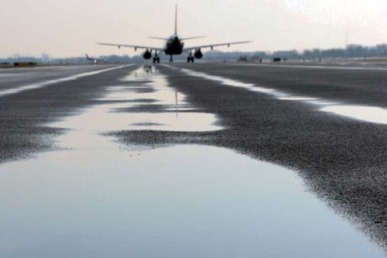 At Philadelphia International Airport, an aircraft on Taxiway S with alleged rutting under the plane. Photo taken Thursday (3-20-2014) morning after a rain. Source of photo: City Controller’s office.