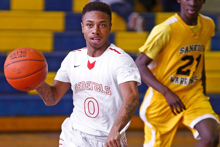 Constitution's Tamir Green dribbles the ball up the court, trailed by
Sankofa Freedom's Ibrahim Dabo.