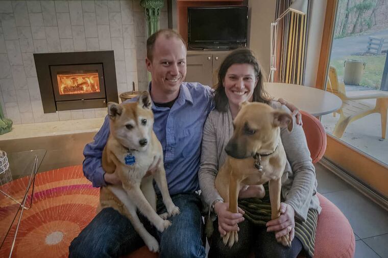 Donald and Jackie Gusic in the study with their dogs Honey, left and Clementine.