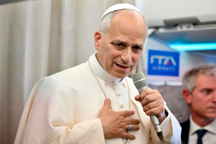 Pope Leo XIV talks to reporters Tuesday aboard the papal plane as he returns from a six-day visit to Turkey and Lebanon.