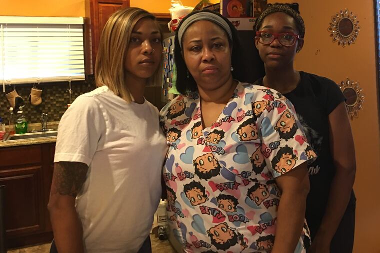 Tamika Watson, flanked by her daughters Tia Finks and Asia Seldon, is outraged that the District Attorney's Office has not charged the man who confessed to killing her daughter.