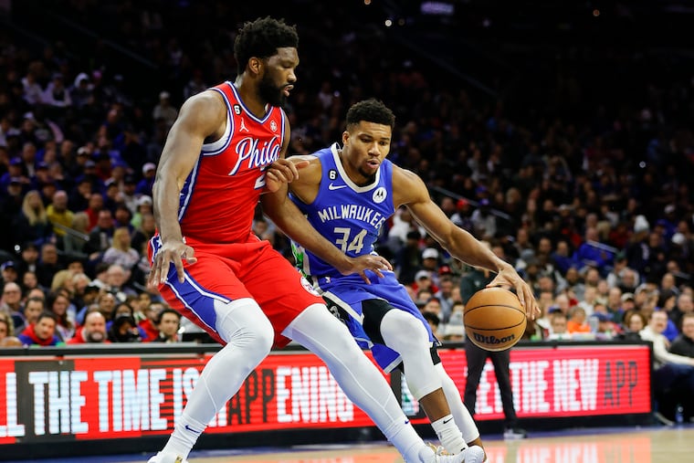 Sixers center Joel Embiid defends Milwaukee Bucks forward Giannis Antetokounmpo in the first quarter of a game on Friday at the Wells Fargo Center.