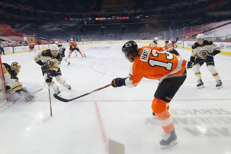 Kevin Hayes tries to make a play behind the net as Boston's Tuukka Rask (left) and Jeremy Lauzon defend. He has 11 points in 13 games for the Flyers.