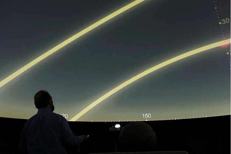 Planetarium Director Mark Percy leads a lesson at the Williamsville North High School planetarium in Williamsville, N.Y., on March 18, in preparation for the upcoming total solar eclipse. Some Philadelphia-area schools are dismissing early or extending the school day on April 8 due to the eclipse.