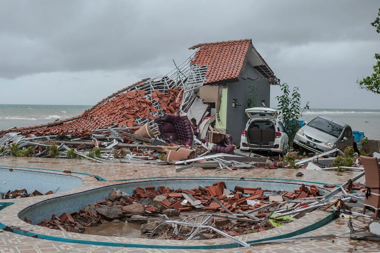 Debris littered a property badly damaged by a tsunami in Carita, Indonesia, Sunday, Dec. 23, 2018. The tsunami occurred after the eruption of a volcano around Indonesia's Sunda Strait during a busy holiday weekend, sending water crashing ashore and sweeping away hotels, hundreds of houses and people attending a beach concert. (AP Photo/Fauzy Chaniago)