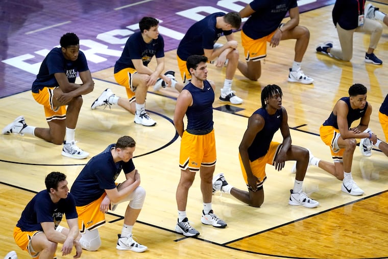 Members of the Drexel basketball team pause for the national anthem before a first-round NCAA Tournament game against Illinois.
