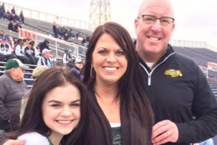 Carson Wentz's family - (from left) stepsister Bailey, stepmother Laurie and father Doug - attend Senior Bowl practice on Thursday.