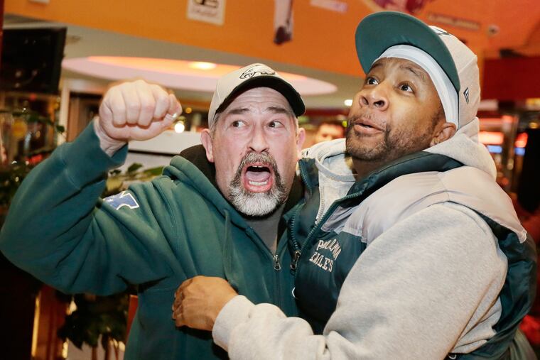 Fans, at Phily Diner Sports Bar in Runnemede, N.J., celebrate the Eagles' victory over the Bears on Jan. 6, 2019.