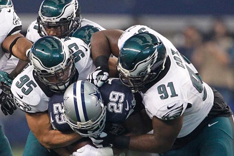 Mychal Kendricks and Fletcher Cox stop Cowboys running back DeMarco Murray. (Ron Cortes/Staff Photographer)