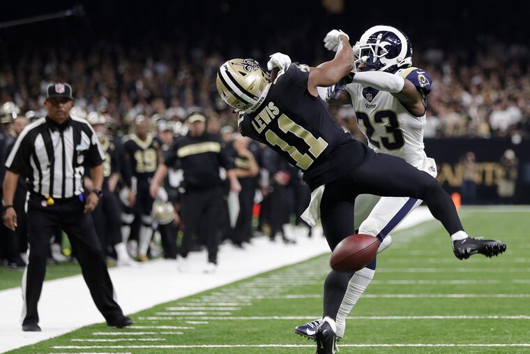 Saints receiver Tommylee Lewis gets hit by Rams defensive back Nickell Robey-Coleman with an official watching. Pass interference wasn't called.