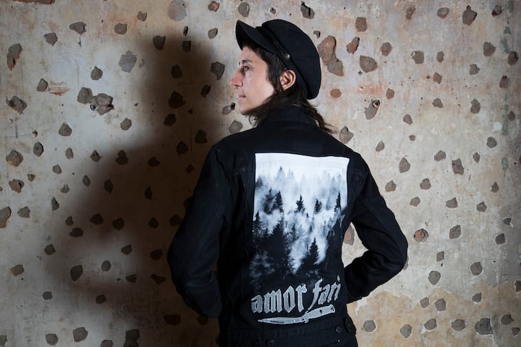 Lauren D'Auria was a devout Christian until she decided to come out as a lesbian and leave the church instead. She is photographed at Palo Santo Wellness Boutique Yoga on Nov. 20, 2019. The back of her jacket says "To love your fate" in Italian. Yoga has provided the sense of community, structure, and support she misses from her years in the church.