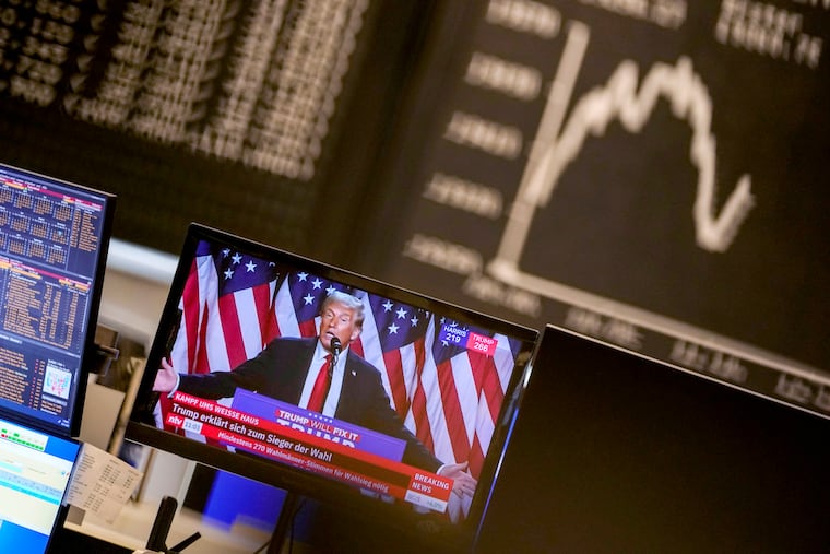 Former President Donald Trump appears on a television screen at the stock market in Frankfurt, Germany, Wednesday, Nov. 6, 2024.
