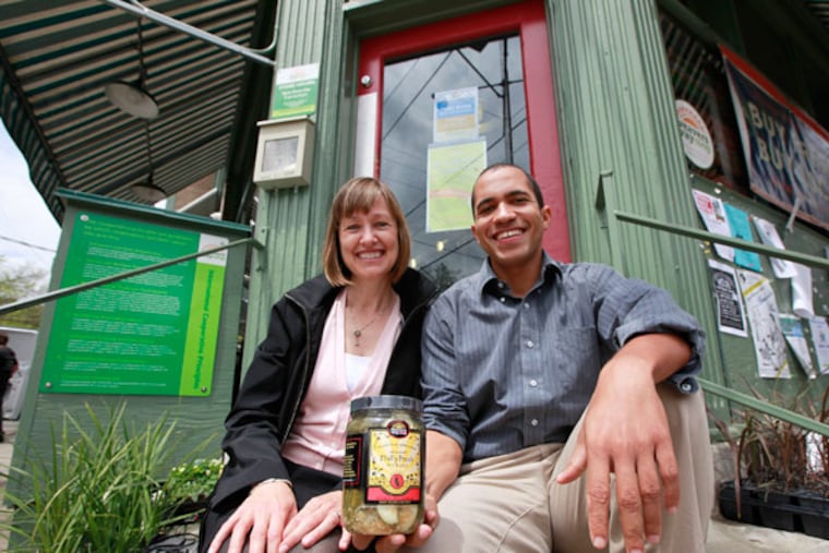 Victor Mallet and Elizabeth Killough with Weavers Way PhillyFresh Pickles outside the Mount Airy co-op. (David Swanson / Staff Photographer)