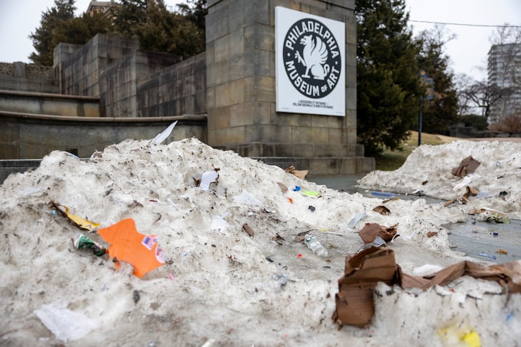 Melting snow begins reveals hidden trash outside the Philadelphia Museum of Art on Friday.