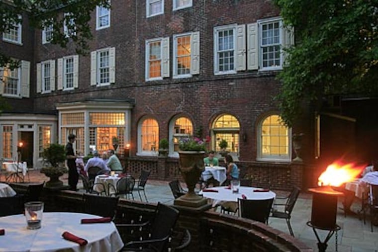 The tables of M Restaurant are in the bluestone courtyard of the Morris House Hotel on Eighth Street. (Akira Suwa/Staff Photographer)