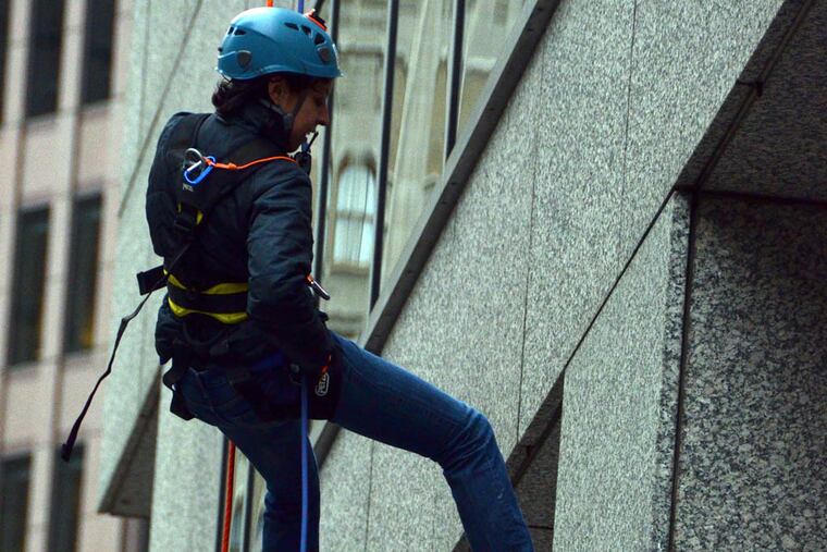 Helen Ubinas, finishing her windy rappel down 31 stories at One Logan Square during a two-day fundraiser for the program. Courtesy of Philadelphia Outward Bound School.
