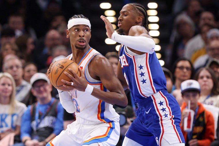 Oklahoma City Thunder guard Shai Gilgeous-Alexander (left) is defended by Sixers' Tyrese Maxey on Sunday.