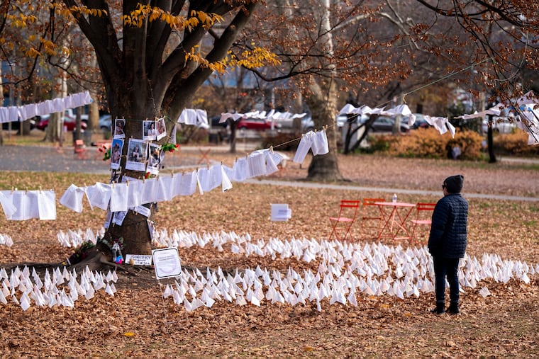 Community resident Hazami Sayed pauses at the Palestine Vigil in Clark Park on Tuesday, after the Philadelphia Parks and Recreation Department postponed their planned removal of what they call a “temporary memorial."