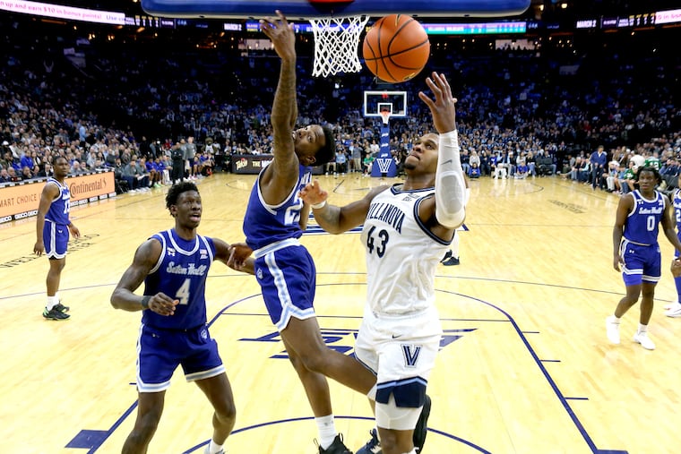 Eric Dixon (right) of Villanova pulls in a rebound in front of Seton Hall's Femi Odukale and Tyrese Samuel in the second half. Dixon had 19 points and six rebounds.