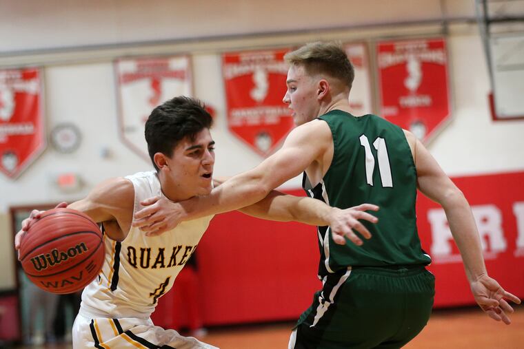 Moorestown's Jagger Zrada dribbles past Camden Catholic's Patrick Corbett in January.