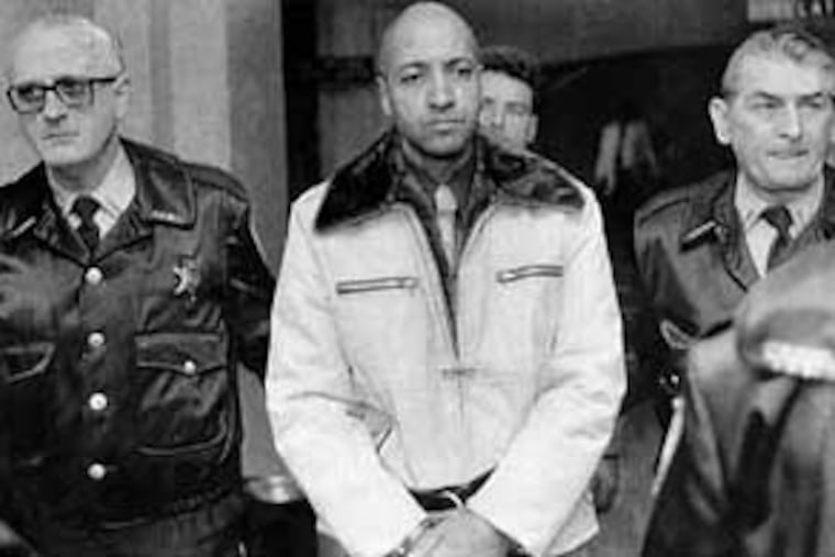 Under heavy guard, convicted murderer George Banks, formerly of Wilkes-Barre, is led through the Luzerne County Courthouse on November 22, 1985. Banks was given the death penalty. (AP file photo)