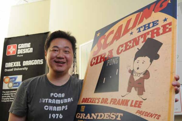 Computer Science Prof. Dr. Frank Lee holds a poster promoting his plan to turn the Cira Center building at 30th St. Station into a giant video game display for the classic computer game Pong to celebrate the start of Philly Tech Week April 19, 2013. A lottery will determine who gets to play the game, with the controllers to be set up at the Art Museum. ( CLEM MURRAY / Staff Photographer )