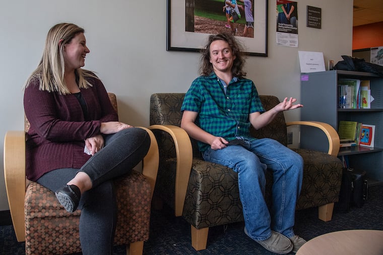 Ryan Moran (right), a senior who gets services at the Kinney Center, interacts with Alli Gatta, associate director of college autism support at St. Joseph's University Thursday. A new residence hall will open at St. Joe's in the fall. The university is home to the Kinney Center for Autism Education and Support.