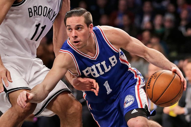 Philadelphia 76ers' T.J. McConnell, right, pushes past Brooklyn Nets' Brook Lopez during the first half of the NBA basketball game at the Barclays Center, Sunday, Jan. 8, 201,7 in New York.
