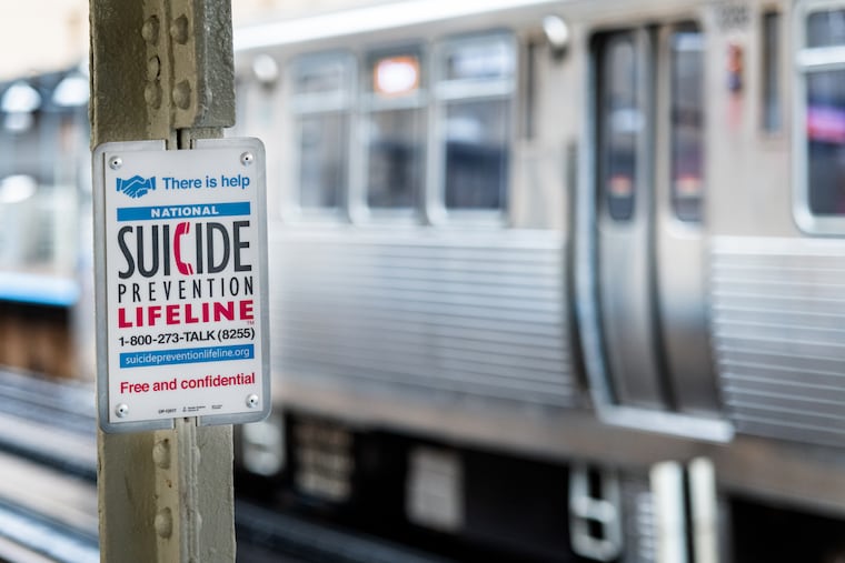 A suicide prevention sign in a subway station in Chicago, Illinois.