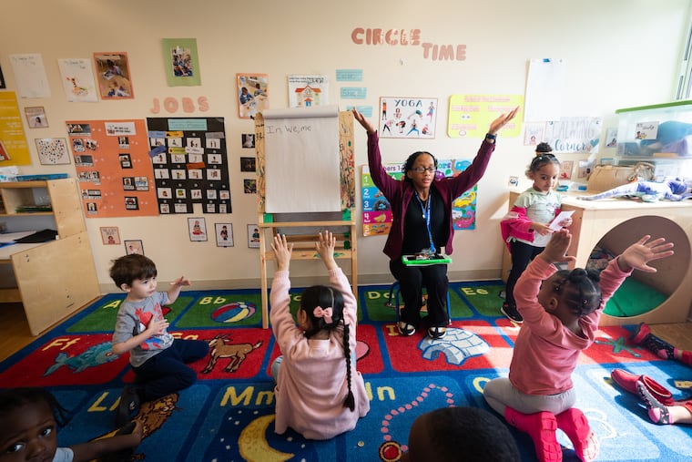 Teacher Denean Nelson leads her students in stretches before settling in for story time at the Kinder Academy in Philadelphia.