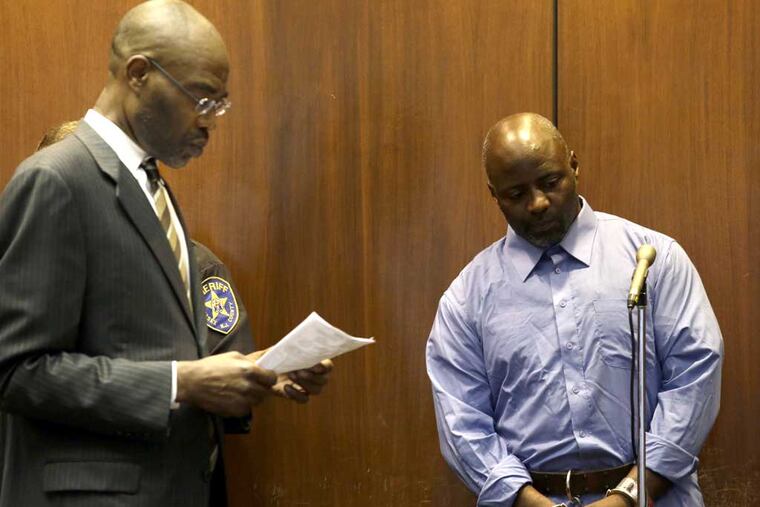 Shawn Custis, right, appears in front of Judge Peter Vazquez, not seen, as public defendant Sterling Kinsale, speaks, during Custis' arraignment at Essex County Superior Court, Tuesday, July 2, 2013, in Newark, N.J. Custis, 42, was arrested in connection with a violent home invasion on June 21, that left a mother beaten in an attack that was captured by nanny camera. (AP Photo/Julio Cortez)