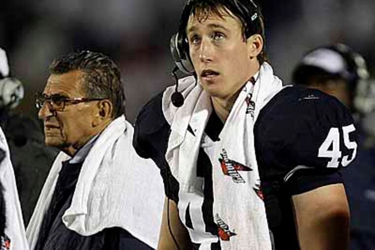 Penn State coach Joe Paterno and team co-captian linebacker Sean Lee work on the sideline during the fourth quarter of an NCAA college football game, Saturday, Sept. 26, 2009, in State College, Pa. Iowa won 21-10. (AP Photo/Carolyn Kaster)